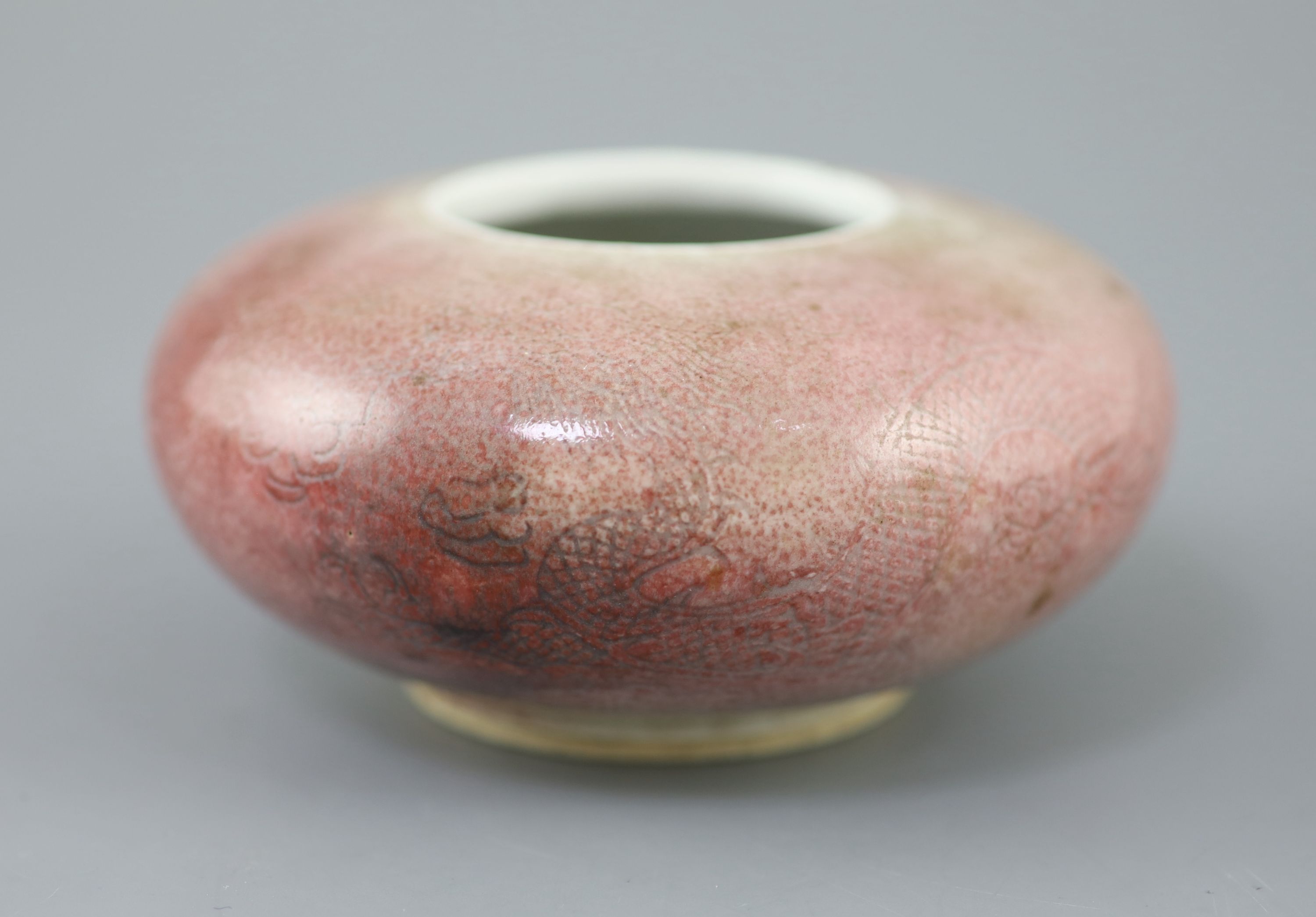 A Chinese peach-bloom dragon water pot, Kangxi six character mark, probably Republic period, 12cm diameter